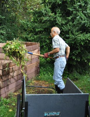 Adding material to compost pile