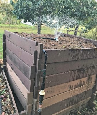 compost pile being watered