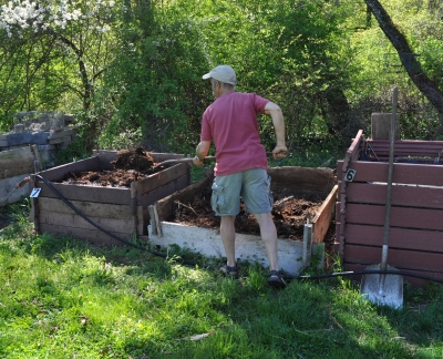 Scooping compost frm the compost bin