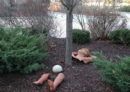 Mulched tree with sculpture